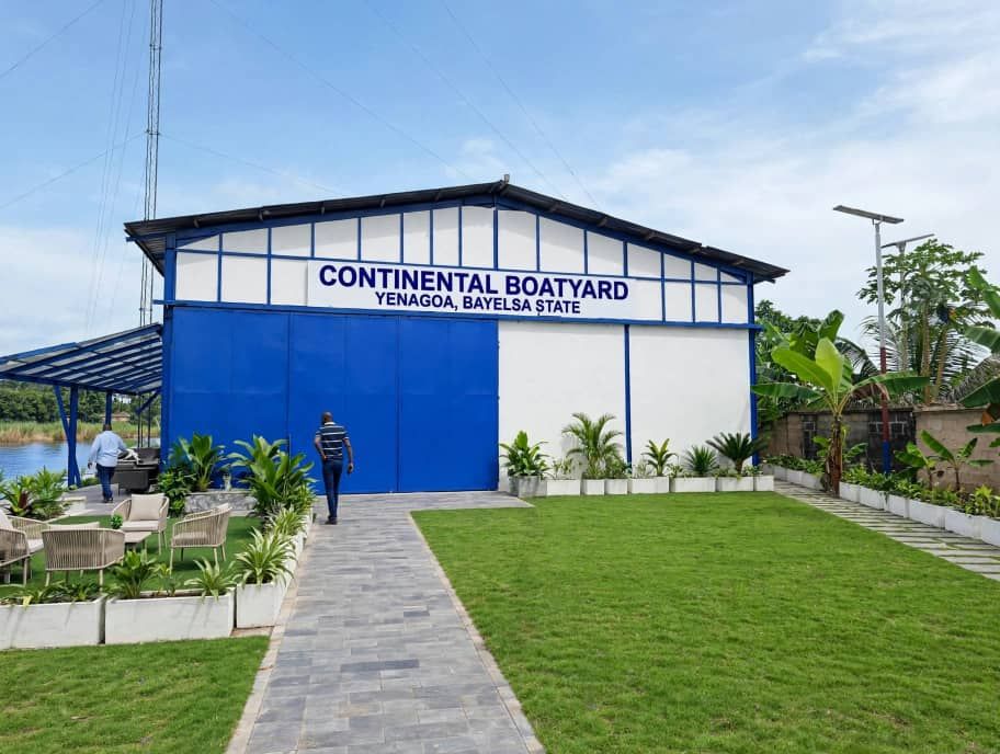 The real Continental Boatyard building in Yenagoa with its blue door and signboard