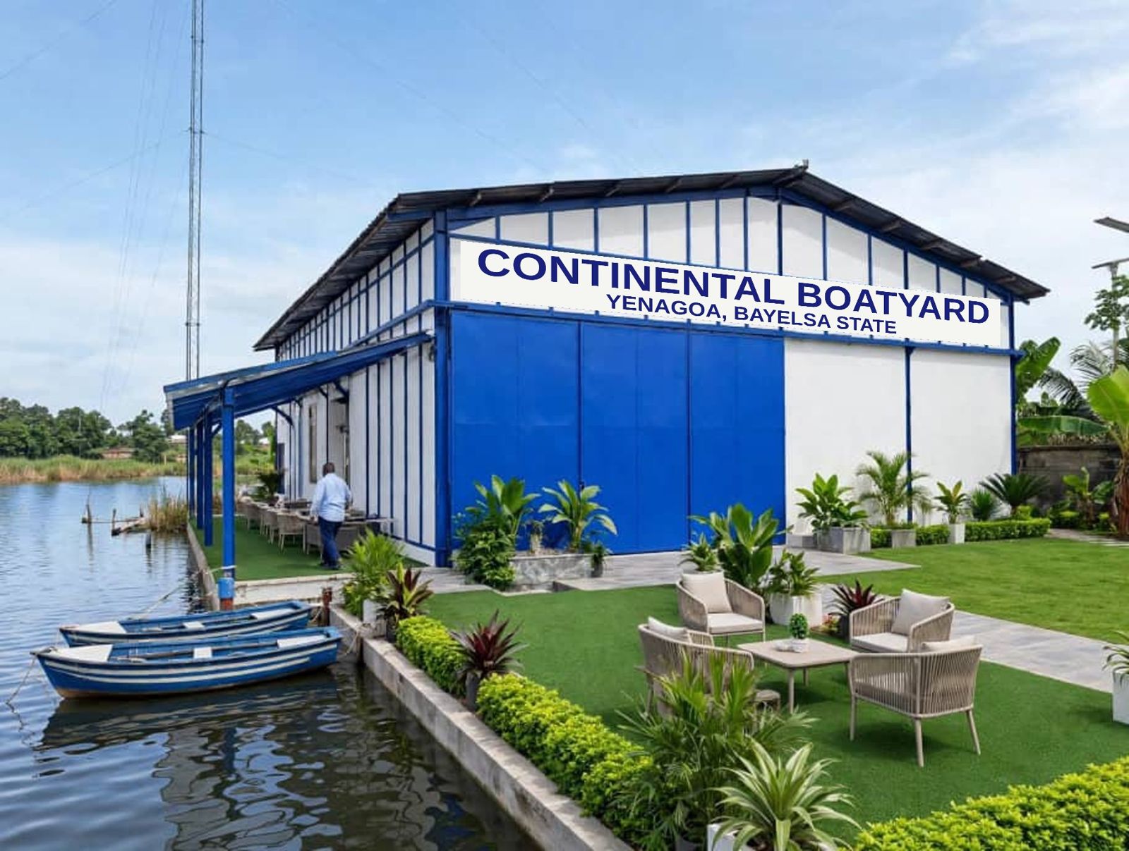Continental Boatyard in Yenagoa: a blue and white waterfront hangar with its signboard, boats moored at the jetty